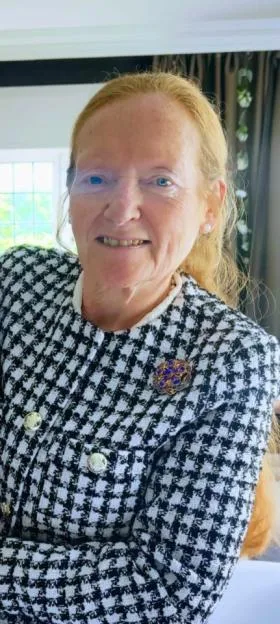 Rose Johnston wearing a black and white houndstooth jacket.