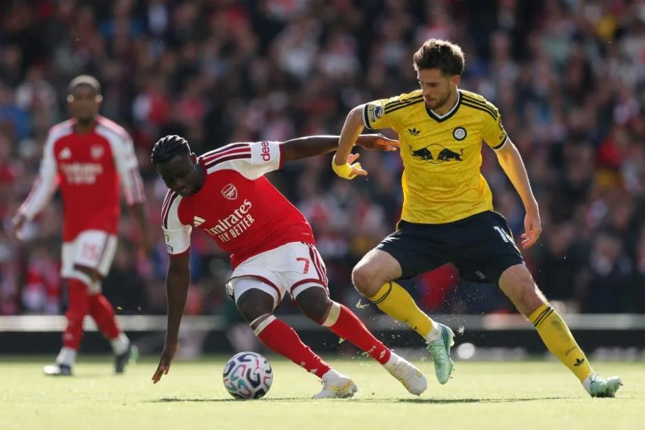 Bukayo Saka of Arsenal is challenged by Anton Stach of Leeds United during a match.