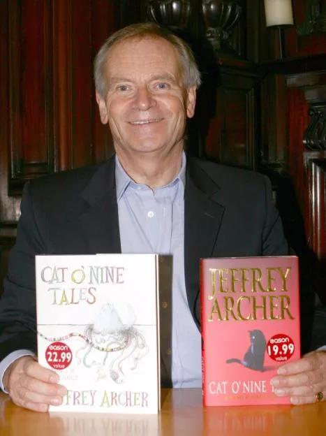 Jeffrey Archer holding copies of his book "Cat O'Nine Tales".