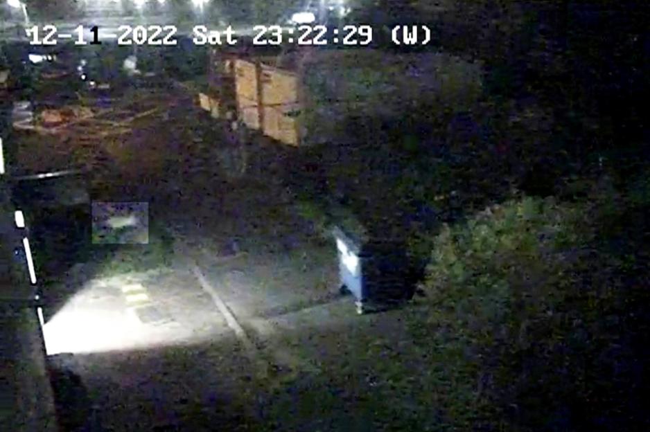 CCTV footage of an outdoor area at night, showing a person falling from a tower block window.