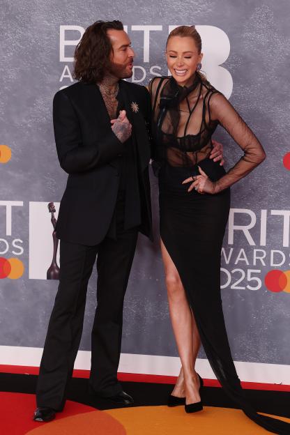 Pete Wicks and Olivia Attwood posing together at The BRIT Awards 2025.