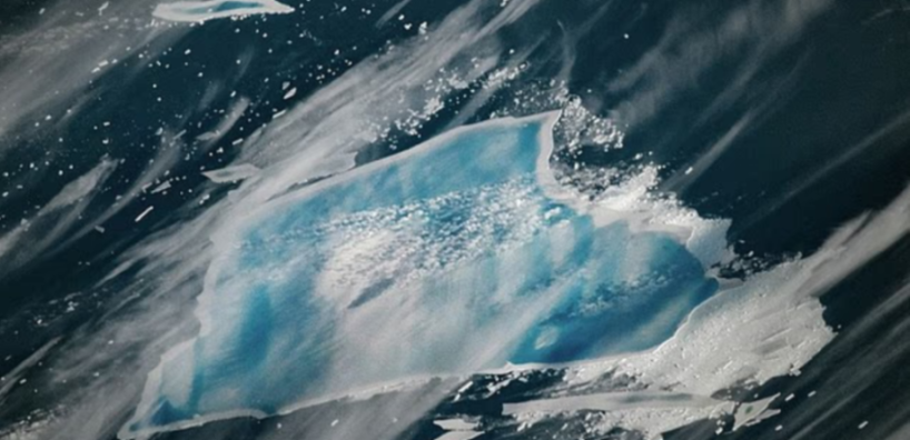 Aerial view of the crumbled A-23A iceberg, showing large and small pieces of ice scattered across dark blue water.