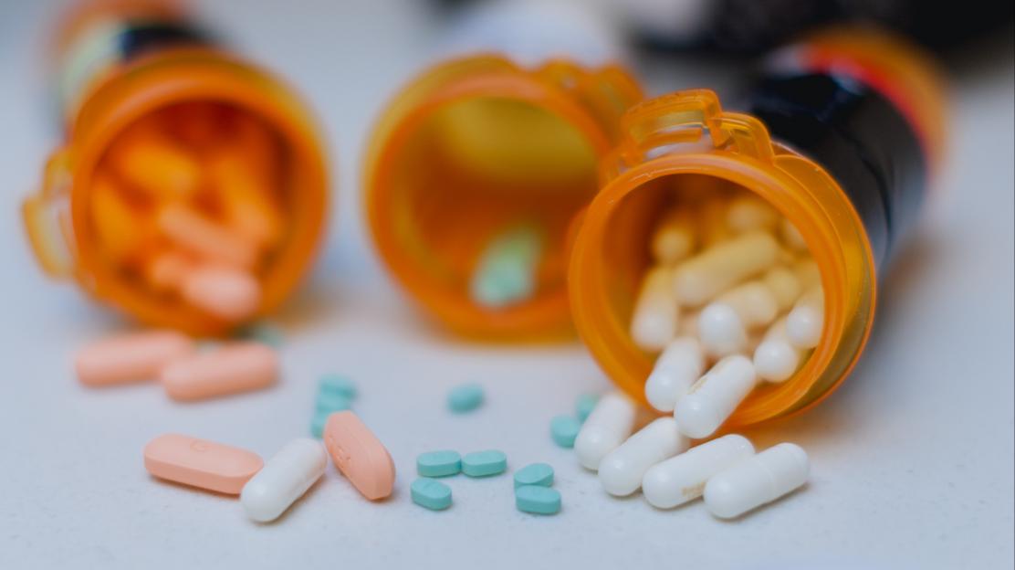ADHD medication spilled from pill bottles.