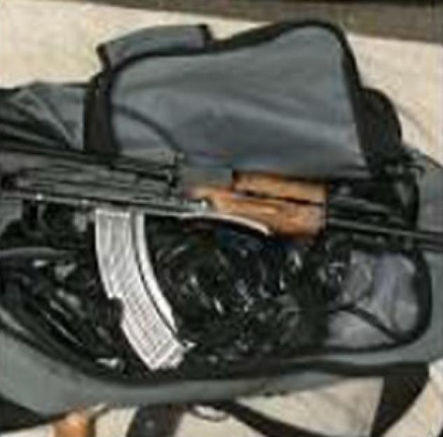 A Kalashnikov assault rifle and ammunition magazines in a bag.