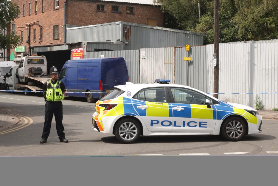 Police car at a murder investigation scene.