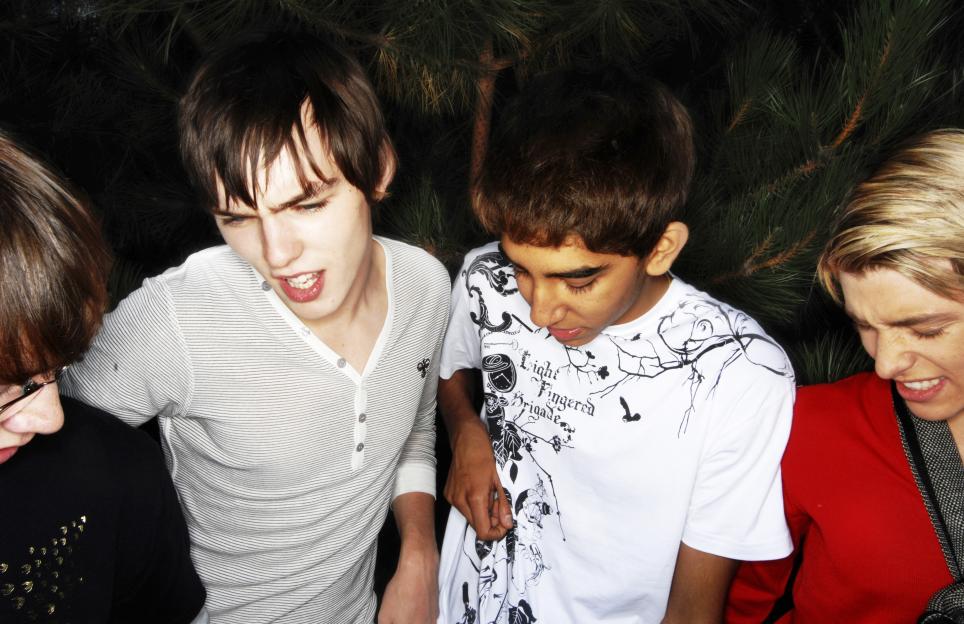 Cast members of the TV show "Skins" including Dev Patel, Nicholas Hoult, Mike Bailey, and Mitch Hewer.