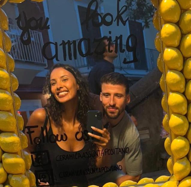Ruben Dias and Maya Jama in a mirror selfie with "You look amazing" written on the mirror.