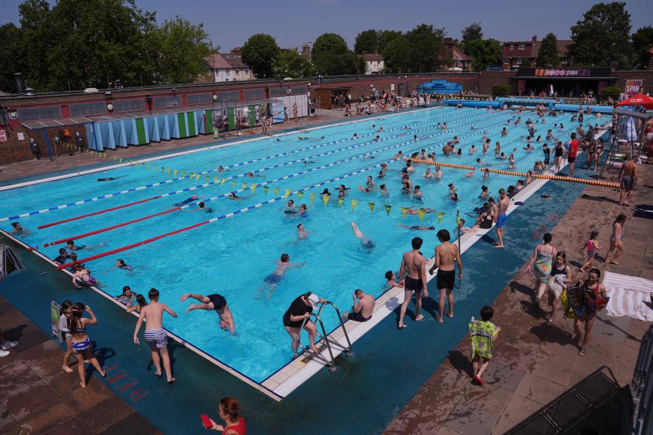 People swimming in Charlton Lido during a heatwave.