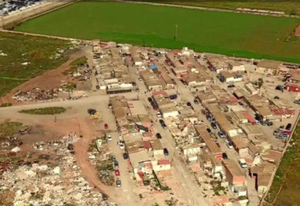 Aerial view of Palma's Son Banya shanty town with numerous cars on unpaved roads between tightly packed shacks.