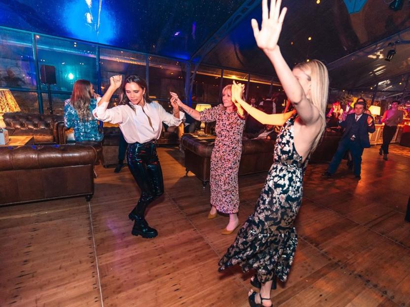 Victoria Beckham dancing with two other women at Brooklyn Beckham's 21st Birthday party.