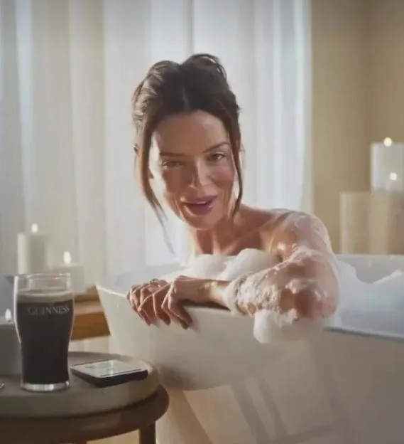 Maura Higgins in a bubble bath in a St Patrick's Day advert with a pint of Guinness nearby.