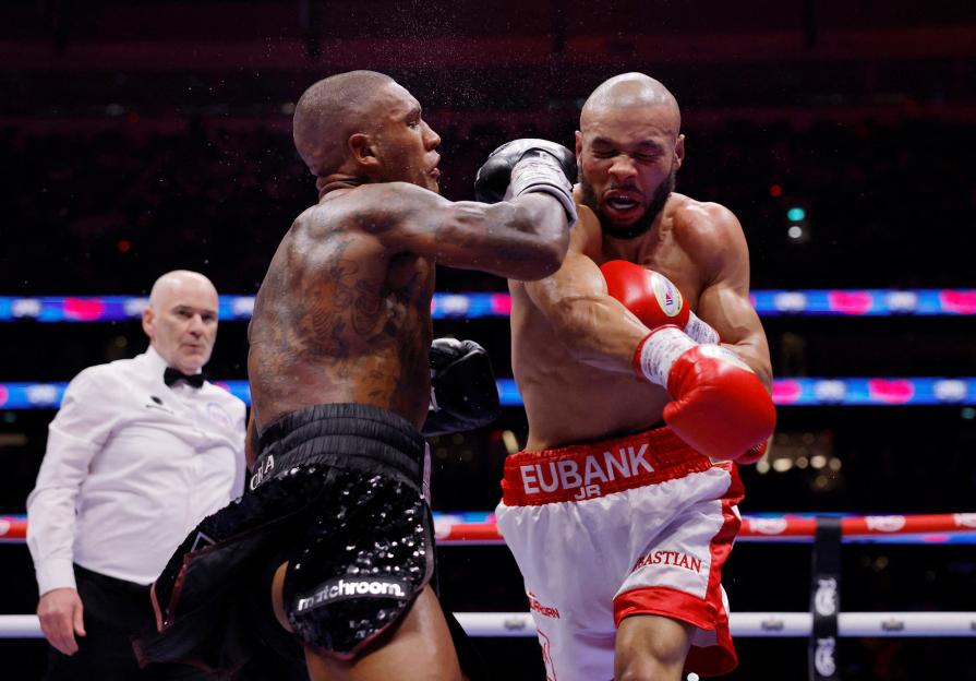Conor Benn throwing a punch at Chris Eubank Jr. during their boxing match.