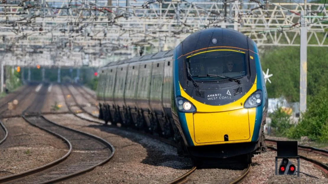 Avanti West Coast Pendolino high-speed train traveling towards the camera at Rugeley Trent Valley station.