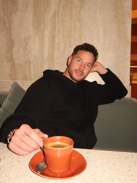 Scott Thomas from Love Island enjoying a coffee.