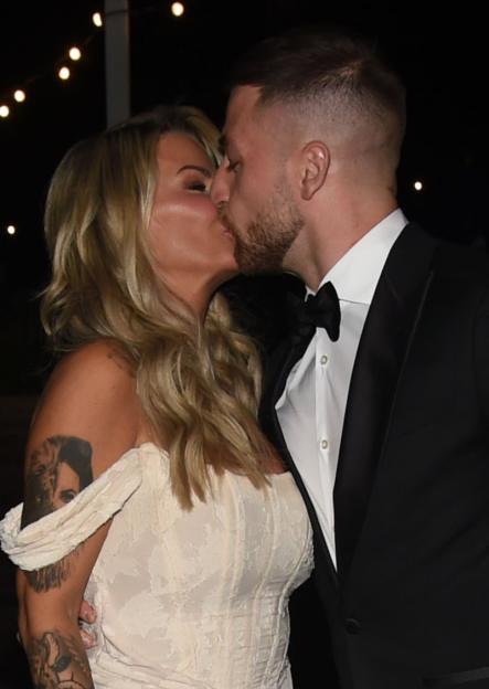Kerry Katona and Paolo Margaglione kissing at The Trauma Research Charity event.