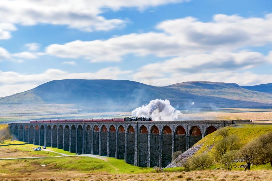 Steam train crossing the Ribblehead Viaduct in the Yorkshire Dales, England.