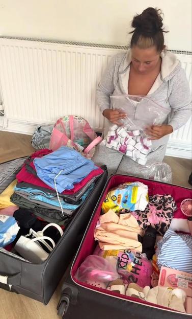 A woman packing individual packets of McDonald's curry sauce into her luggage.