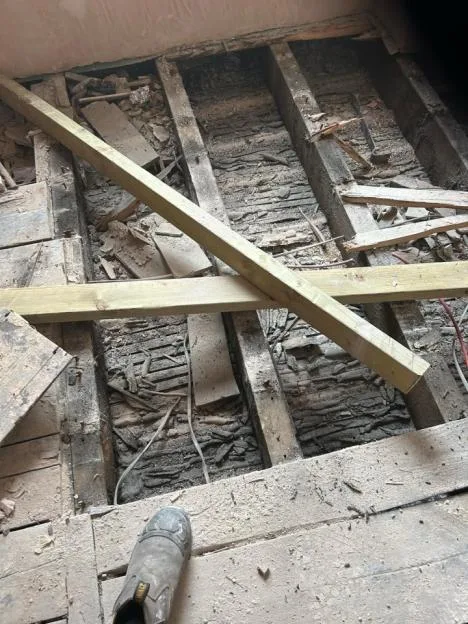 Demolished floor joists and debris.