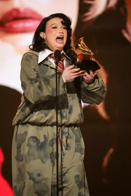 Lola Young holds a Grammy award on stage at the 68th Annual Grammy Awards.