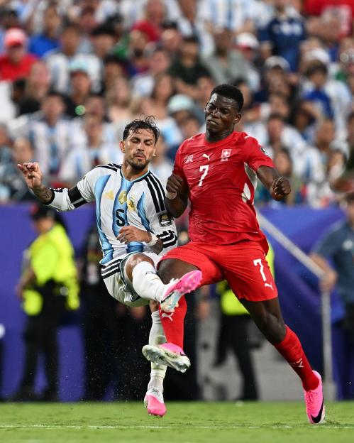 Kansas City, United States. 13th July, 2026. Leandro Paredes of Argentina (L) and Breel Embolo of Switzerland (R) fight for possession during a FIFA Men's World Cup 2026 quarter-final football match between Argentina and Switzerland at Kansas City St