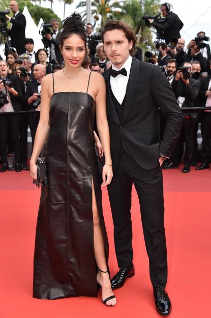 Hana Cross in a black leather dress and Brooklyn Beckham in a tuxedo at the Cannes Film Festival.