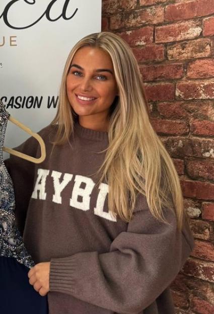 Taylor Gidley, Miss Lancashire 2024, smiling while holding a formal dress.