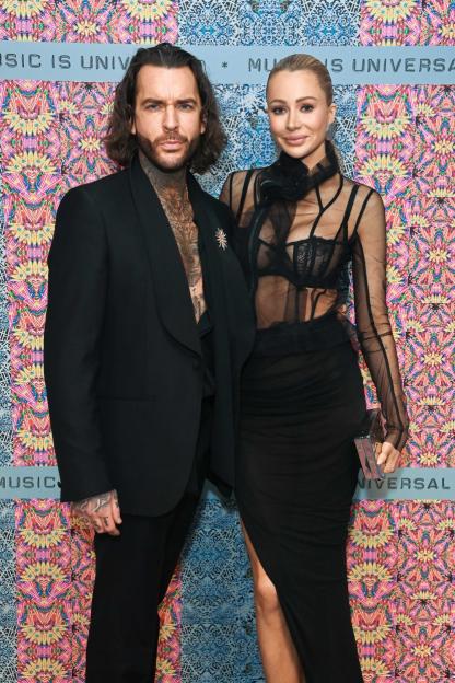 A man and a woman posing at the Universal Music BRIT Awards After-Party.