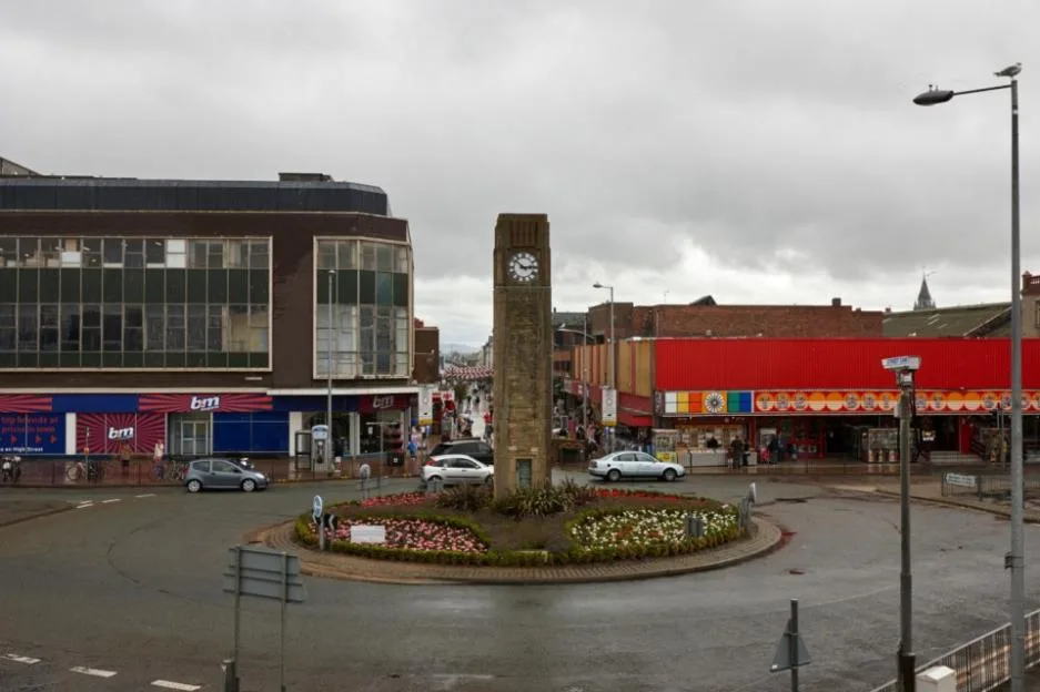 Rhyl clock tower standing in a roundabout on a wet day in North Wales.