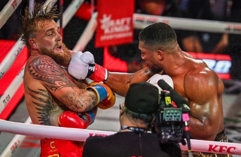 Boxer Jake Paul being hit in the head by Anthony Joshua's left jab.