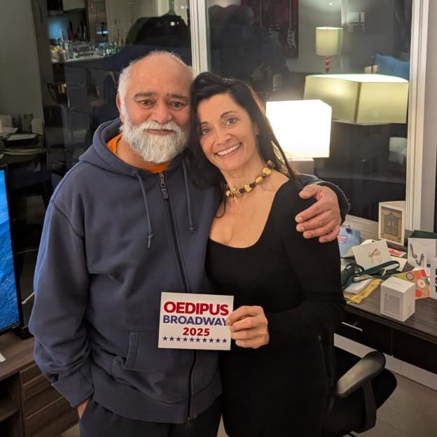 Bhasker and Rebecca Saker holding a sign for "OEDIPUS BROADWAY 2025"