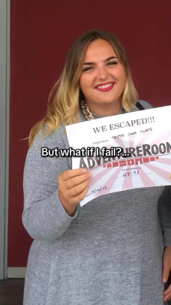 A woman holding a certificate that says "WE ESCAPED!!!" from an adventure room.