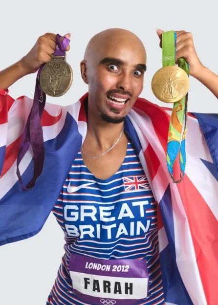 Maya Jama dressed as Mo Farah for Halloween, holding two gold medals and draped in a Union Jack flag.