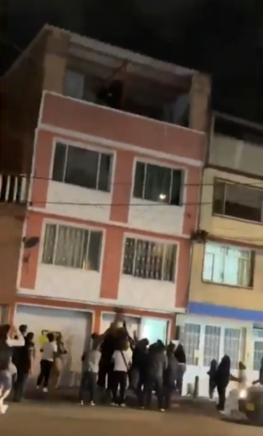 A two-year-old boy falling from a building, caught by a crowd of people.
