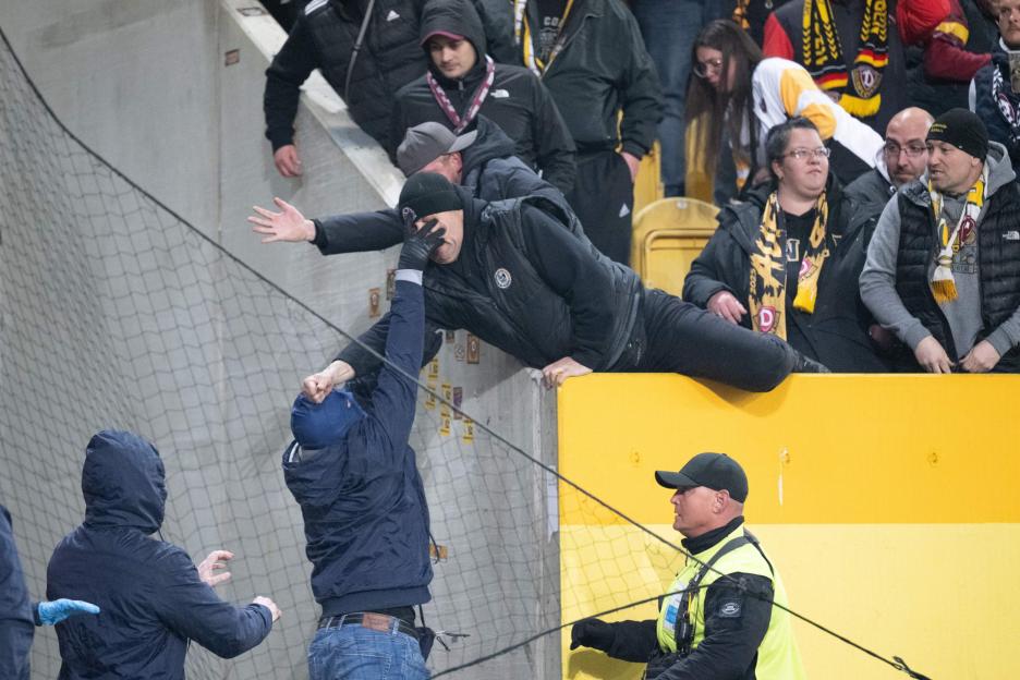Intense Showdown: Riot Police Pursue Football Ultras Amid Fiery Flares and Chaos on the Pitch