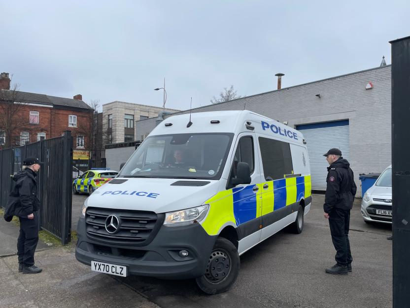 Police officers and vans outside Legacy Independent Funeral Directors.