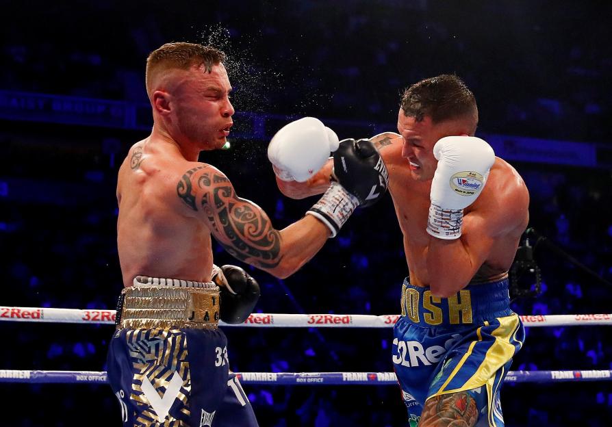 Carl Frampton being punched by Josh Warrington in a boxing match.