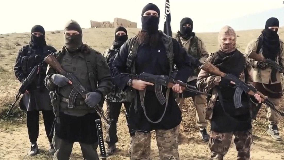 Propaganda photo showing masked ISIS militants with assault rifles in Syria.