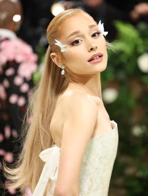 Ariana Grande in an iridescent white strapless gown with butterfly accents near her eyes at the Met Gala.