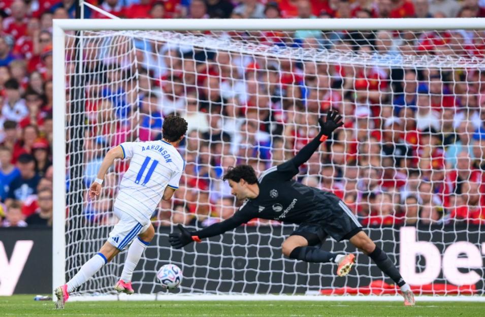 Aaronson of Leeds United scores a goal past the Manchester United goalkeeper.