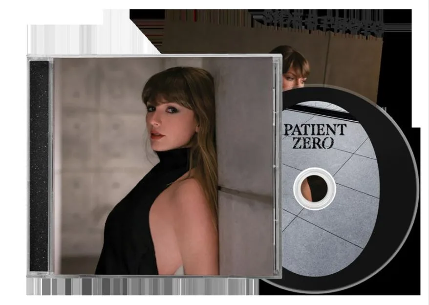 Taylor Swift's "Patient Zero" CD with cover art showing her in a black top, and the CD itself with "PATIENT ZERO" printed on it.