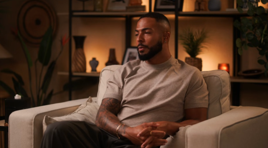 Tyler West sitting on a couch for an interview.