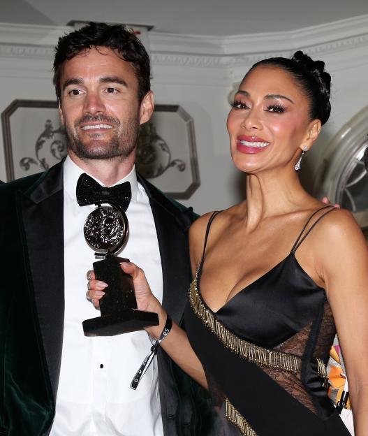 Thom Evans and Nicole Scherzinger pose with a Tony Award at an after-party.