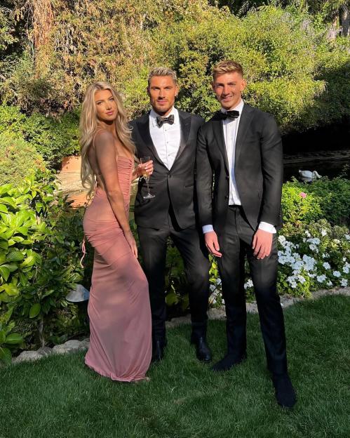 Chris Appleton, his daughter Kitty, and son Billy, dressed in formal attire in a garden setting.
