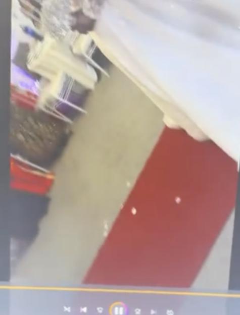 A video frame showing a white wedding dress and a red carpet, with a video player interface visible at the bottom.