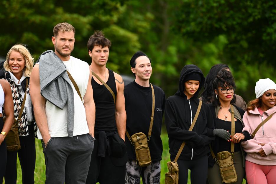 Caroline Stanbury, Colton Underwood, Rob Rausch, Johnny Weir, Maura Higgins, Tiffany Mitchell, and Candiace Dillard Basset stand outside in casual clothes.