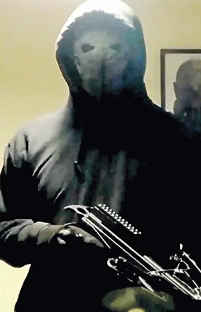 Jaswant Singh Chail, the 19-year-old suspect, wearing a mask and holding a crossbow.