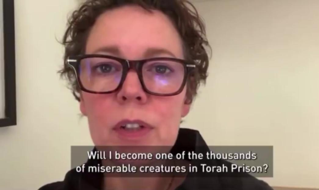 Actress Olivia Colman wearing glasses, speaking with the subtitle "Will I become one of the thousands of miserable creatures in Torah Prison?"