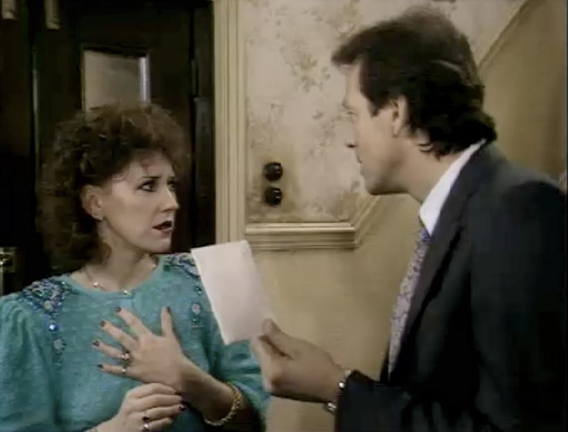 Den Watts presents Angie Watts with divorce papers.