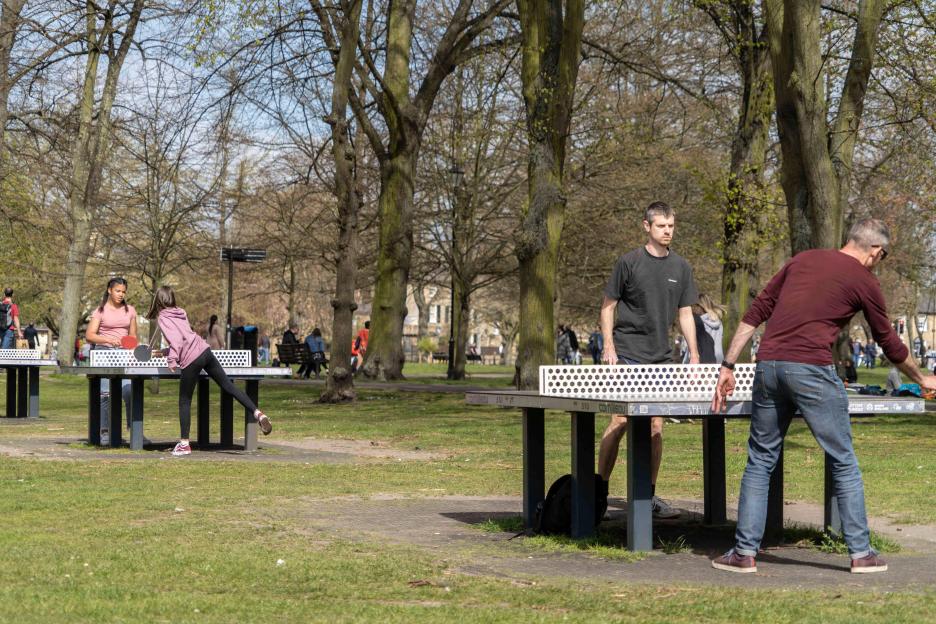 People playing table tennis in Cambridge city center.