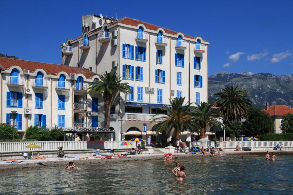 Montenegro Tivat beach and Hotel Palma with mountains in the background.